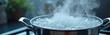 © Pete - Close-up of boiling water in a pot on a stove with bubbles and steam. Water boils in metal pot on kitchen stove. Steam rises from boiling water with bubbles in pot.