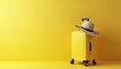 © Pete - Yellow suitcase and straw hat ready for holiday trip. Bright yellow background offers empty copy space for your vacation or travel advertisement, marketing text or promo.