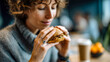 © ABF_MATEO - Woman with curly hair savoring the aroma of a sesame seed bun burger in a cozy café, anticipation evident on her face. Delicious food.