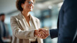 © Kateryna - Handshake of business professionals at office gathering faceless young woman and man defocused meeting background professional agreement moment corporate greeting scene busine