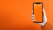 © shobakhul - Person holding modern smartphone with bright orange screen against vibrant solid background