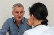 © Jelena - Doctor comforting male patient delivering bad news