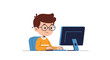 © Priya - Smart young boy with glasses smiling while sitting at a desk and using a desktop computer for learning or playing online games.