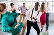 © JackF - Pair of woman and African American man enjoying of contemporary boogie woogie dance in choreo class. Exciting hobby, active lifestyle, passion for dancing and choreography
