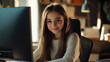 © Alina Tymofieieva - Young girl smiles while working on a computer in a cozy, illuminated room during the evening hours
