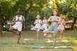 © JackF - Group of multinational people practitioner performing Garudasana in sunny garden
