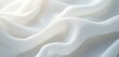 © Pete - Close up photo of soft white fabric with waves. Delicate textile material has elegant texture. Light and shadows create a calm background. Smooth flowing cloth.