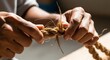 © Suterno - Close-up hands crafting rough organic cord using natural raw materials