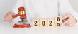 © Jo Panuwat D - 2025 end year to Happy New Year 2026 with judge gavel on table. Law, lawyer, judgment, justice auction and bidding concept