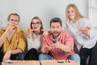 © Volodymyr - Friends watching TV. Pizza party together. Happy group friends eat pizza. Evening with tasty food. Friendship and home party. Joyful people having fun and relaxing together on pizza party.
