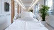 © siraphol - Hospital bed in bright corridor with pillow and medical monitor