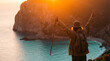 © Video80X - A joyful adventurer at sunset over a coastal landscape, perfect for travel and adventure themes.