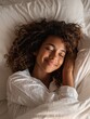 © Johannes - satisfied pretty afro american young woman has peaceful sleep lies in bed on comfortable pillow sees pleasant dreams has gentle smile enjoys softness of bedclothes being under white blanket no logos