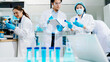 © Nuttapong punna - Laboratory team analyzing samples with digital science icons, biotech tools, and research equipment.