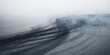 © AkuAku - Tire marks on asphalt surface used as a textured background for layouts and design projects
