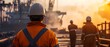 © Ytnart - Workers in safety gear observe operations at a busy port during sunset, showcasing teamwork and industrial activity in a vibrant environment.