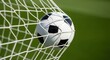 © Nataly - Goal net with soccer ball shown against green field. Goal net action shows scored goal. Concept goal net as symbol of sport, with classic ball,