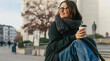 © olezzo - Woman in the city. Nice portrait of middle aged woman in eyeglasses holding coffee cup outdoors