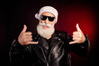 © deagreez - Cool Santa rocker in leather jacket with white beard and sunglasses giving double thumbs up in festive shot
