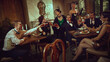 © master1305 - Group of stylish friends making a festive retro toast in warm vintage setting. Concept of holiday nightlife, bar events, retro glamour campaigns, fashion storytelling with cheerful emotion.