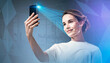 © ImageFlow - Woman holding smartphone with facial recognition scan, digital geometric overlay, modern office background, concept of biometric authentication and security