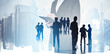 © ImageFlow - Silhouettes of business people overlaid on modern city buildings, with a man writing on a notepad in the foreground, symbolizing teamwork and strategy