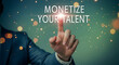 © Pixel Studio - Monetize your talent concept with a business professional pointing to the words on a screen representing innovation entrepreneurship and financial success in the digital age