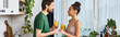 © LIGHTFIELD STUDIOS - Young couple shares joyful moments in a cozy kitchen filled with warmth and laughter