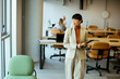 © BGStock72 - Business professional in a modern office environment engaging with colleagues