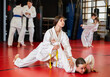 © JackF - Engrossed sportsmen teen girls in pair conduct training battle in oriental fighting judo technique. School of martial arts. Reinforcement strength of mind and body. Sport to max. .