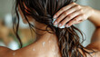 © Maikia Desings - Woman applying conditioner to wet dark hair in a shower