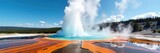 Majestic Yellowstone geyser erupting, hot water and steam rising against a vibrant blue sky A stunning display of nature's power in Wyoming's iconic national park , eruption, awesome