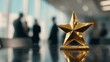 © Rifqi - Close-up shiny golden star trophy on table with blurred managers or directors in background, concept for award ceremony, business achievement and company success