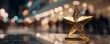 © Rifqi - Close-up of a golden star trophy on a reflective surface with blurred background, concept for achievement recognition, celebrating success and career excellence