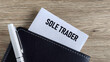 © Shanorsila - Sole Trader Business Concept: Card with Text Emerging from a Black Wallet with Pen Representing Self-Employment