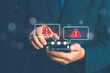 © pornnipa - Cybersecurity threat with fake email and SMS alerts on smartphone, showing phishing scams, identity theft risk, online fraud, and red warning icons to highlight mobile security awareness.