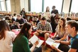 © Rawpixel.com - Diverse group of young adults studying in a library. Students, books, and learning. Engaged in discussion, sharing ideas, and collaborating in a bright space. Diverse group of people photography.
