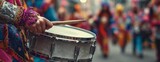 Drummer playing snare drum in colorful costume during carnival parade  
