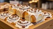 © PixelPro Creative - A tray of freshly baked cinnamon rolls with icing and pecans, a warm and comforting treat, ready to be enjoyed