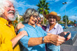 © unai - Happy senior friends taking selfie in city during vacation