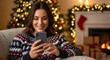 © Iuliia - Happy caucasian woman holding smartphone, checking social media or messaging friends during Christmas holidays. Holiday season concept for technology and remote connection.