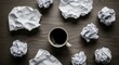 © Agus Through Lens - Top view of a black coffee cup on a wooden desk surrounded by crumpled paper balls representing stress