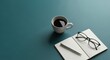 © dreamdes - Cup of coffee next to an open notebook with a pen and glasses. Morning routine concept for productivity and creative work. Flat lay minimal.