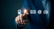 © alvi - A man in a suit points to a glowing telephone icon, part of a series of communication symbols including phone, email, and chat.