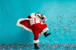 © deagreez - Santa in red with a boombox dances through confetti in a playful holiday scene for Christmas and party vibes