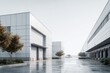 © Nirwasita - Modern industrial complex featuring large loading bays and reflective pavement under bright, overcast skies