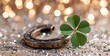 © Shahin - A lucky four leaf clover rests beside an antique horseshoe on glitter