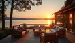 © miss irine - Wooden deck with comfy sofas and chairs overlooks calm lake at sunset. House view shows scenic water landscape with distant hills and warm sky. Peaceful evening at lakeside retreat.