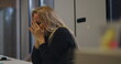 © Marco - Close-up of overwhelmed middle-aged woman burying head into arms at office table, exhibiting signs of burnout, pressure, and fatigue during stressful work moment