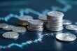 © Sulastri - Close-up shot of stacks of silver coins with a blurred blue-red stock chart background